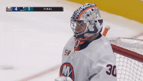 a hockey game between the islanders and the sharks