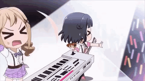 two anime girls are standing next to each other and one of them is playing a keyboard .