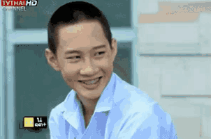 a young man with braces on his teeth is smiling in front of a tv .