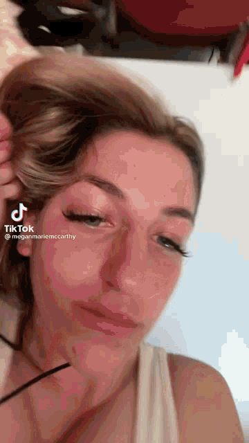 a close up of a woman 's face with a tiktok watermark on it