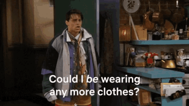 a man in a colorful jacket is asking if he could be wearing any more clothes