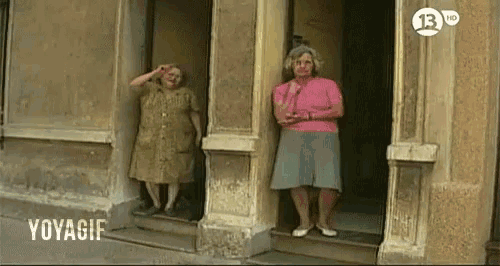 two women standing in front of a building that says voyager on the bottom right