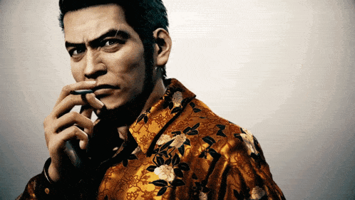 a man wearing a floral shirt is talking on a cell phone