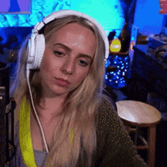 a woman wearing headphones is looking at something