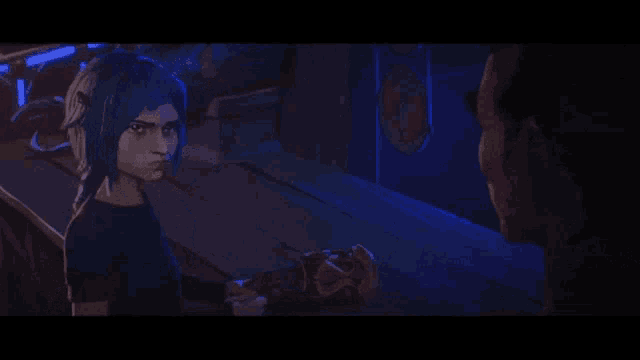 a woman with blue hair is standing next to a man in a dark room holding a microphone .