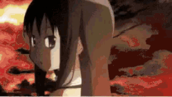 a girl in a bathing suit is standing in front of a fire .