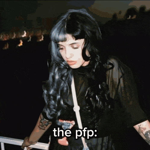 a woman is holding a flaming object in front of her face and the words the pfp are below it