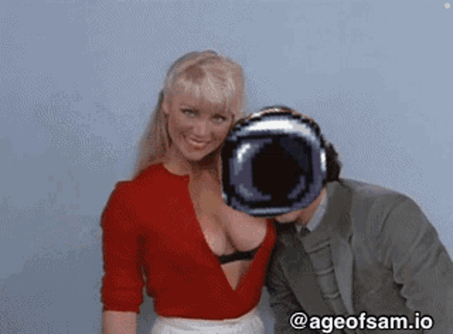 a man and a woman are posing for a picture with ageofsam.io on the bottom