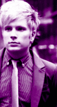 a man in a suit and tie is wearing a purple background