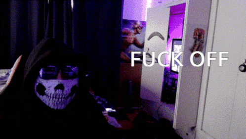a person wearing a skull mask says fuck off in a room