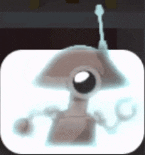 a cartoon robot with antennas is sitting on a white table .