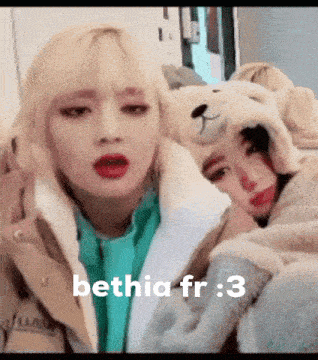 two girls are sitting next to each other wearing teddy bear hats and the words bethia fr : 3 on the bottom .