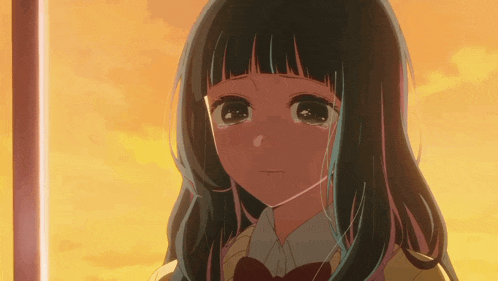a girl in a school uniform is crying with a sunset in the background