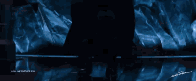 a man in a helmet is standing in a dark room with a red sign that says off