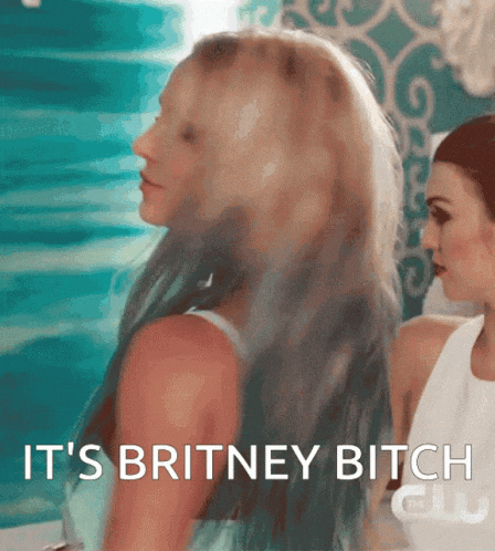 a woman with blue hair says it 's britney bitch while standing next to another woman