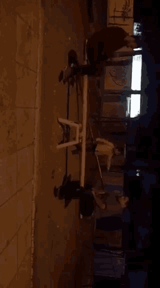 a man is sitting on a seesaw in the dark
