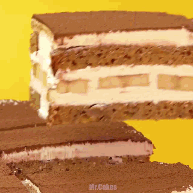 a stack of slices of cake with the words mr.cakes on the bottom right