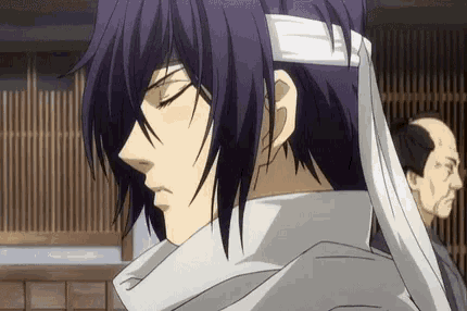 a man with purple hair and a bandage around his head