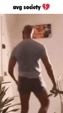 a man is dancing in front of a broken heart and the words avg society are above him
