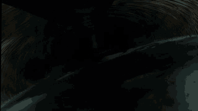 a dark background with a few spots of light on the bottom