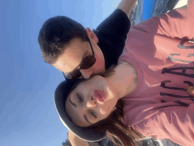 a man kisses a woman on the cheek while she wears a shirt that says chicago
