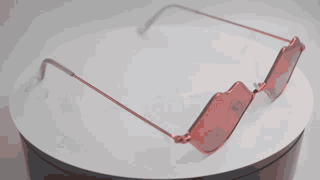 a pair of red lips shaped sunglasses are on a white surface