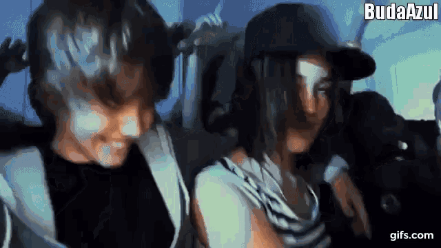 a man and a woman are sitting next to each other with the words budaazul written on the bottom right