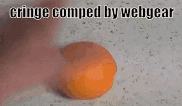 a close up of an orange with the words cringe comped by webgear written above it