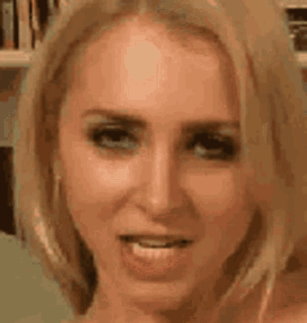 a close up of a woman 's face with a blurred background .