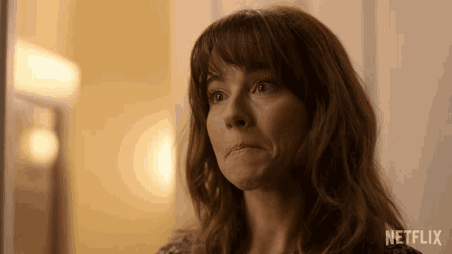 a close up of a woman 's face with the netflix logo visible