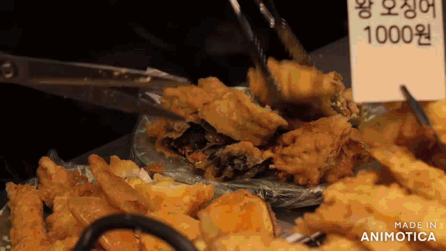a plate of fried food with a sign that says 1000