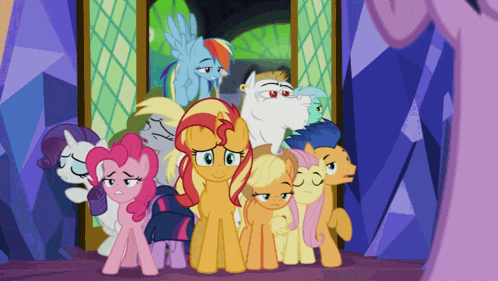 a group of ponies standing next to each other