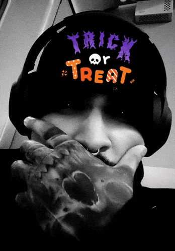 a person wearing headphones has trick or treat written on their hat