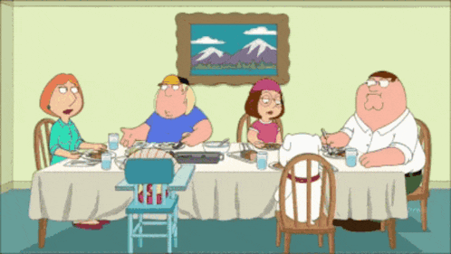 a cartoon family sits around a table with a picture of mountains in the background