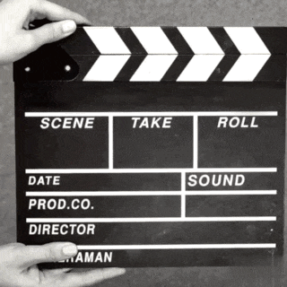 a person is holding a clapper board that says take roll and scene