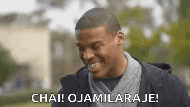 a man is smiling and saying chai ! ojamilaraje !