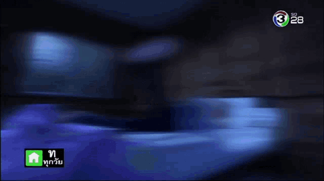 a woman laying on a bed with the number 28 on the screen