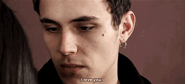 a close up of a man 's face with the words " i love you " on the bottom