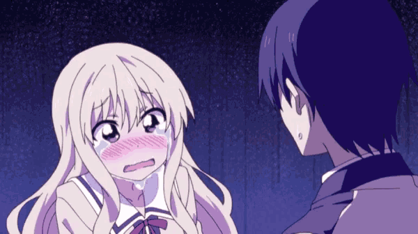 a girl with blonde hair is crying while standing next to a boy