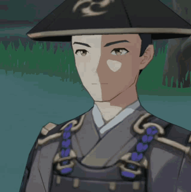 a man wearing a hat with a symbol on it is standing in the grass