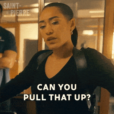 a woman says " can you pull that up " while standing in front of a window