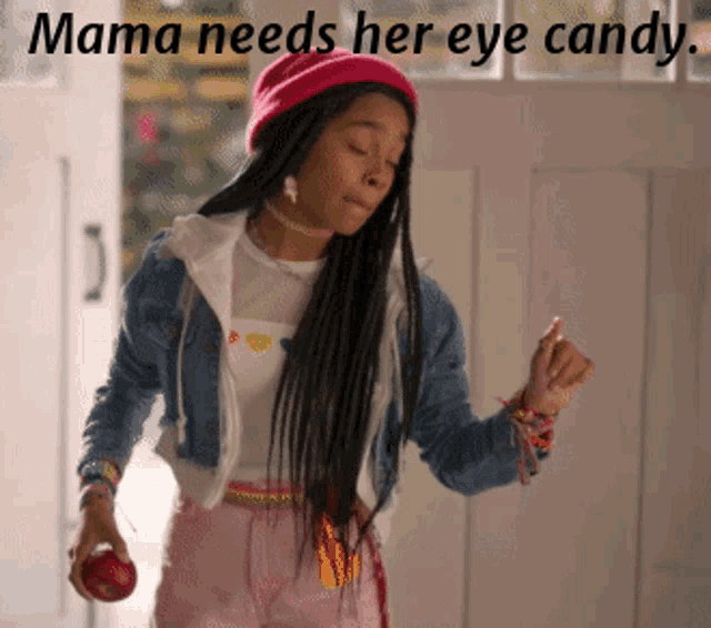 a girl in a pink hat is holding an apple with the words mama needs her eye candy above her