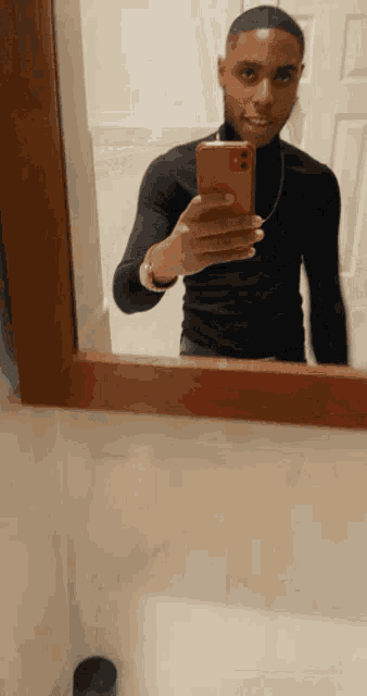 a man is taking a picture of himself in the mirror