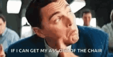 a man in a suit is making a funny face and says `` if i can get my ass out of the chair ''