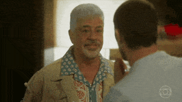 a man with a beard talks to another man