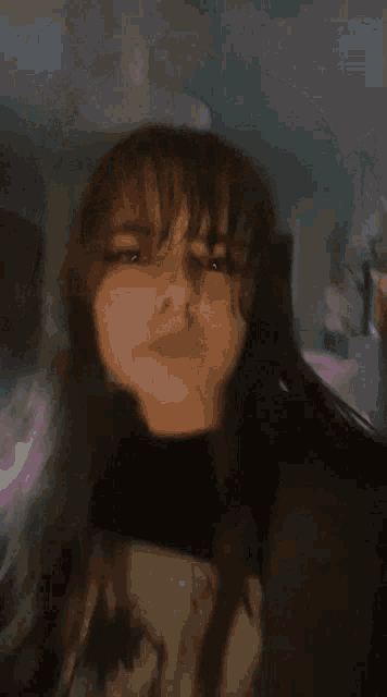 a girl with long hair is wearing a black shirt that says ' s ' on it