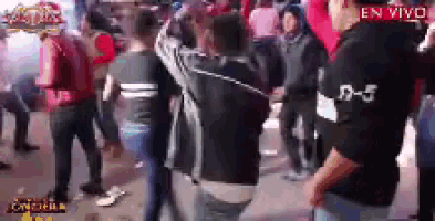 a group of people are dancing in a crowd with a man wearing a shirt that says d-5