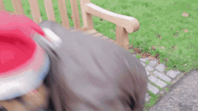 a person wearing a santa hat is laying on a bench
