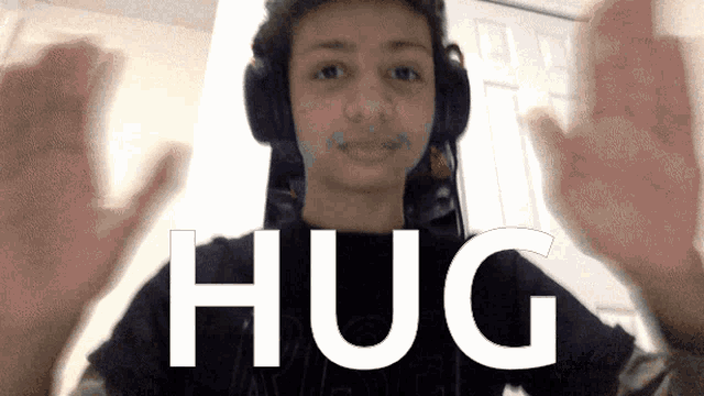 a boy wearing headphones and a shirt that says hug on it