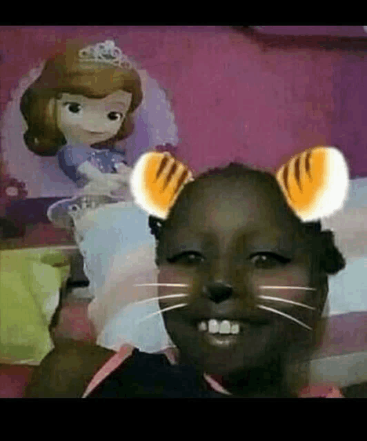 a little girl is wearing a cat mask in front of a picture of a princess